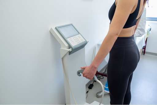 A woman standing on a body composition analyzer, emphasizing the importance of nutrition-related metrics in COPD management.