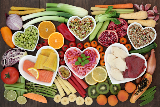 Heart-shaped dishes filled with fruits, vegetables, and grains illustrating the impact of diet on COPD.