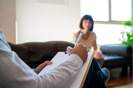 Close-up of therapist's hand taking notes, stressing mental health support for COPD patients.