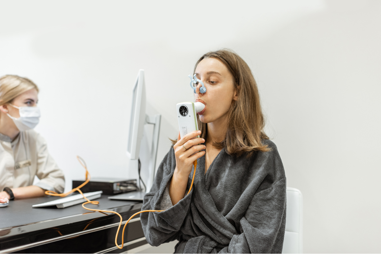 Woman undergoing a spirometry test to assess lung function