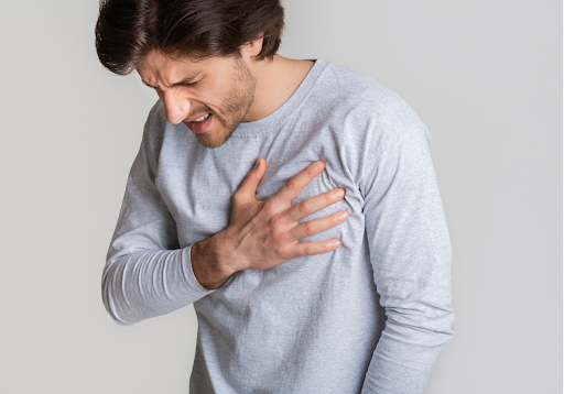 Man clutching his chest in pain, indicating possible asthma or COPD symptoms.