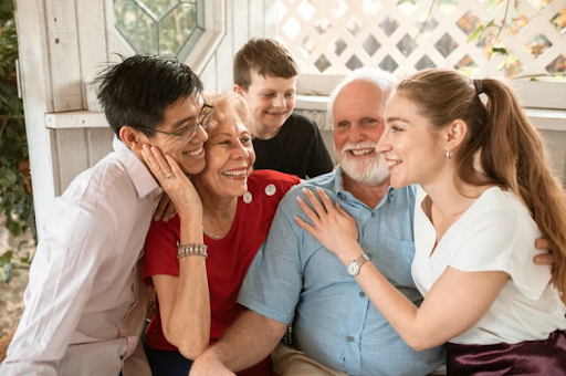 A multi-generational family embracing and smiling, highlighting the importance of family support in COPD management.
