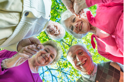 A group of elderly individuals smiling and looking down, symbolizing community and support in managing COPD.