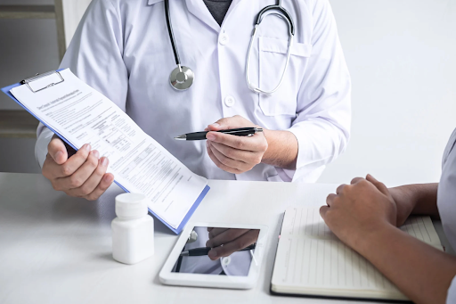 Healthcare provider explaining oxygen therapy to a patient, with a clipboard and medication on the table.