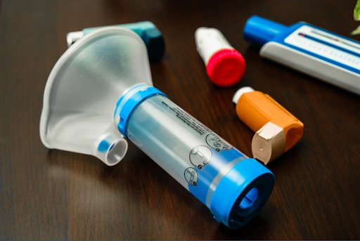Various inhalers, including metered-dose and dry powder inhalers, arranged on a table for respiratory therapy and COPD treatment.