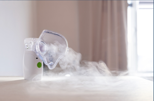 A mesh nebulizer emitting mist, ideal for portable respiratory therapy.