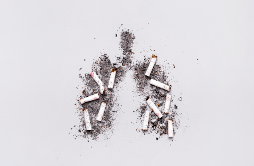 Illustration showing how smoking causes COPD, with cigarette butts and ashes arranged in the shape of lungs.