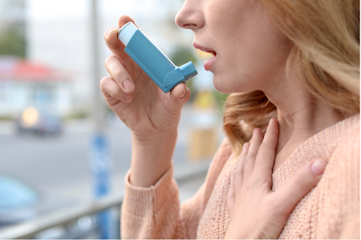 Woman using an inhaler for asthma-COPD overlap management.