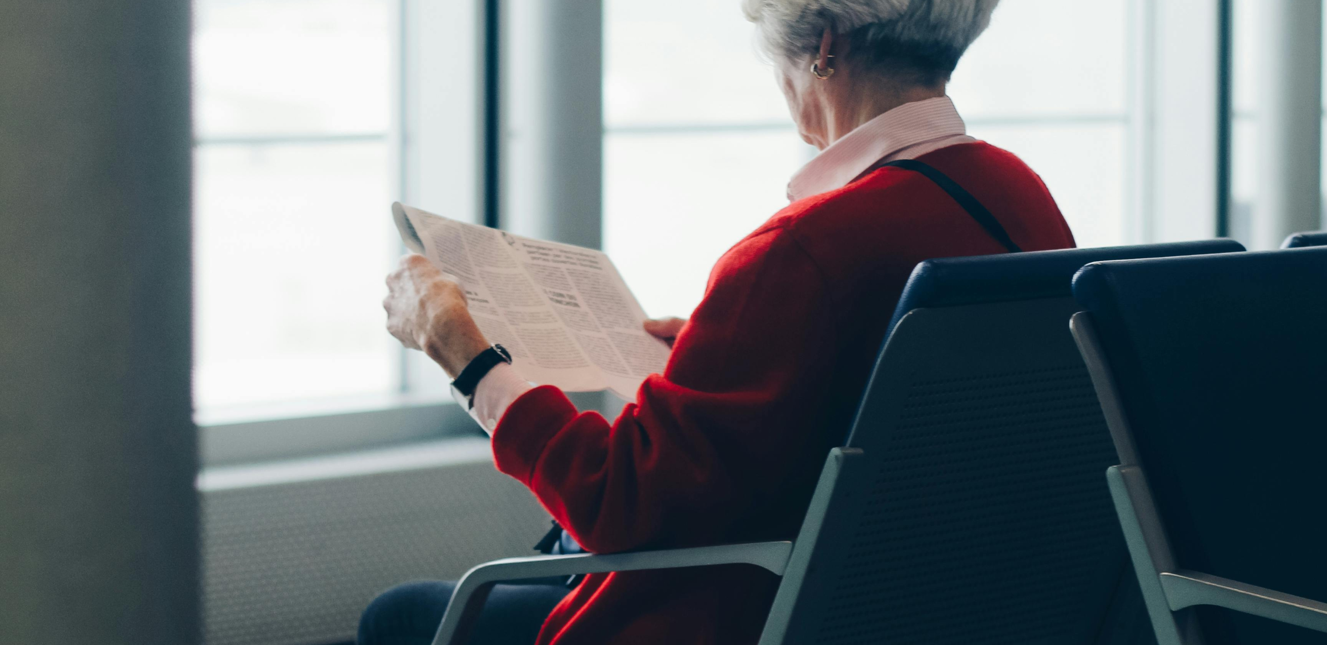 A woman sitting in a doctor's waiting room, awaiting testing for COPD.